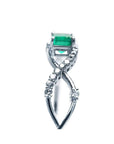 Emerald-cut emerald and natural diamond bangle bracelet in 14K white gold.