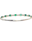 women's emerald bangle bracelet flexible made in 14k yellow gold and genuine Colombian emeralds.