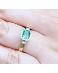 0.93 ct. solitaire Colombian emerald ring in 14K yellow gold, bezel set.