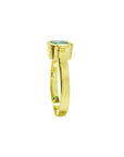 0.93 ct. solitaire Colombian emerald ring in 14K yellow gold with a bezel setting.