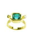 A colombian emerald solitaire ring bezel set made of 14k yellow gold.