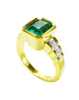 An emerald-cut bezel set emerald ring for women, on top and side view profile position.