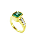 An emerald-cut bezel set emerald ring for women, on top and side view profile position.