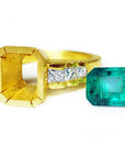 A 18k yellow gold mounting ring with a loose emerald to be set on a side.