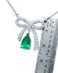 pear shaped Emerald bowtie necklace mined in Muzo Colombia, complemented with high quality natural diamonds pave set