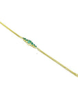Women's 14K yellow gold bracelet with sparkling medium deep green Colombian emeralds.