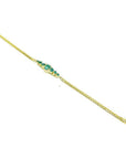 Women's 14K yellow gold bracelet with sparkling medium deep green Colombian emeralds.