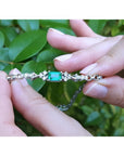 1.08 carat Muzo Colombian emerald bracelet in 14K white gold with rectangular emerald-cut and diamond accents.