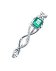 14K white gold bangle bracelet with a central emerald-cut green emerald and entwined diamond strips.