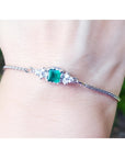 A square emerald-cut bracelet Colombian emerald with accent diamond in 14k white gold.