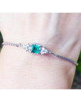 A square emerald-cut bracelet Colombian emerald with accent diamond in 14k white gold.