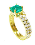 A yellow gold emerald bridal ring with matching band, top and side profile view.