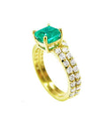 A yellow gold emerald bridal ring with matching band, top and side profile view.