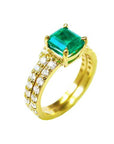 A natural emerald bridal ring with matching band set in yellow gold, top and lateral side profile visibles.