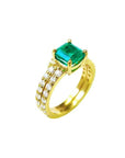 A natural emerald bridal ring with matching band set in yellow gold, top and lateral side profile visibles.