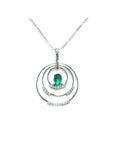 A distant view of a triple circle of life natural colombian emerald pendant made in 14k white gold.