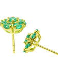 Underside profile view of a pair of emerald cluster earrings push backs in 18k yellow gold.
