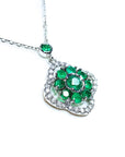A 14k white gold necklace with genuine round cut colombian emeralds cluster pendant.