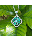 14K white gold cluster necklace with natural Colombian emeralds and diamond 4-leaf clover design.