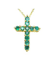 14K yellow gold cross pendant necklace with eleven round-cut Colombian emeralds.