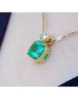 3.43 ct. emerald cushion cut pendant in 18K yellow gold with a small round diamond accent.