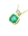 This 18k yellow gold cushion cut emerald pendant necklace displays the topside and galley perspective.