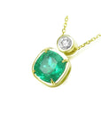 3.43 ct. cushion cut emerald pendant with a round diamond accent in 18K yellow gold.