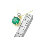 3.43 ct. deep bluish-green emerald cushion cut pendant in 18K yellow gold with a small diamond accent.