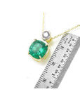 3.43 ct. deep bluish-green emerald cushion cut pendant in 18K yellow gold with a small diamond accent.
