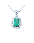 Emerald-cut emerald pendant with halo diamonds in 14K white gold on a chain.