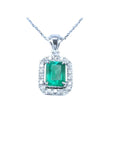 Emerald-cut emerald pendant with halo diamonds in 14K white gold on a chain.