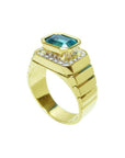 Men's 18K yellow gold ring with a bezel-set emerald-cut emerald and diamond accents.