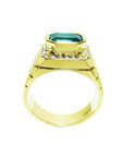 Men's 18K yellow gold ring with a bezel-set emerald-cut green emerald and diamond accents.