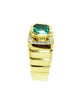 Men's 18K yellow gold ring with a bezel-set emerald-cut green emerald and diamond accents.