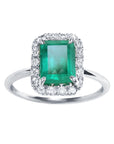 A rectangular emerald-cut encircled by a halo diamond emerald ring in 1k white gold topside view.