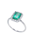 1.44 ct emerald-cut Muzo emerald ring with halo diamonds in 14K white gold.