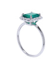 Emerald and diamond ring in white gold side profile view.