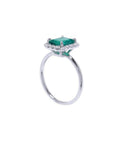 1.44 ct emerald-cut Muzo emerald ring with halo diamonds in 14K white gold.