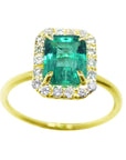 This natural colombian emerald rectangular emerald-cut is encased in a halo of natural diamonds, yellow gold ring.