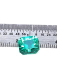 3.60 ct GIA certified loose Colombian emerald, medium bluish green, shown with a ruler.
