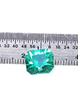 3.60 ct GIA certified loose Colombian emerald, medium bluish green, shown with a ruler.