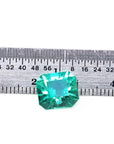 3.60 ct GIA certified loose Colombian emerald, medium bluish green, shown with a ruler.