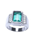 Men's 18K white gold ring with a bezel-set emerald-cut bluish-green emerald and side diamonds.