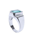 Men's 18K white gold ring with a bezel-set emerald-cut bluish-green emerald and diamond accents.