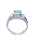 Men's 18K white gold ring with a bezel-set emerald-cut green emerald and diamond accents.