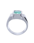 Men's 18K white gold ring with a bezel-set emerald-cut green emerald and diamond accents.