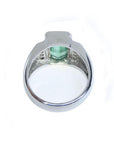 Men's 18K white gold ring with a bezel-set, vibrant emerald-cut Muzo Colombian emerald.