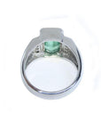 Men's 18K white gold ring with a bezel-set, vibrant emerald-cut Muzo Colombian emerald.
