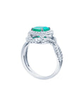 18K white gold ring with a vibrant emerald-cut emerald and sparkling halo diamonds.