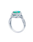 18K white gold ring with a vibrant emerald-cut emerald and sparkling halo diamonds.